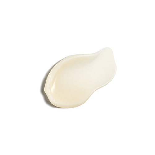 Een druppel van de amberkleurige, vloeibare textuur van de Natura Bissé Essential Shock (R)evolution Collagen Matrix op een witte achtergrond.