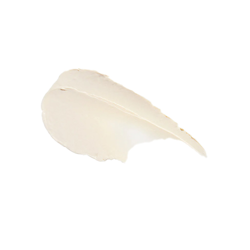 Een close-up van de rijke crème achtige textuur van de Sun Slick SPF 50 minerale zonnebrandstick in een zachte beige tint.
