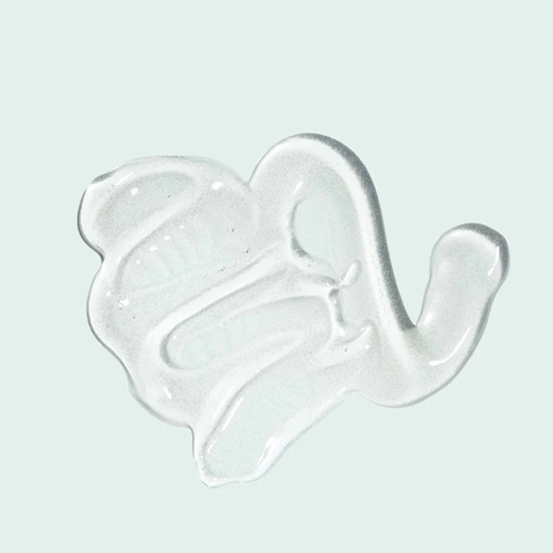 Een macro-opname van een heldere, glanzende gel-textuur van de ORMEDIC Balancing Lip Enhancement op een lichtblauwe achtergrond.