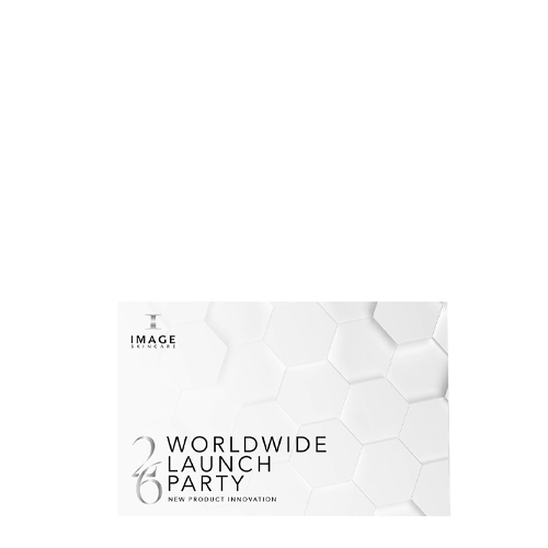Een luxe witte geschenkverpakking van IMAGE Skincare met de tekst 'Worldwide Launch Party - New Product Innovation' en een zilveren '26' op een achtergrond met een geometrisch honingraatpatroon.