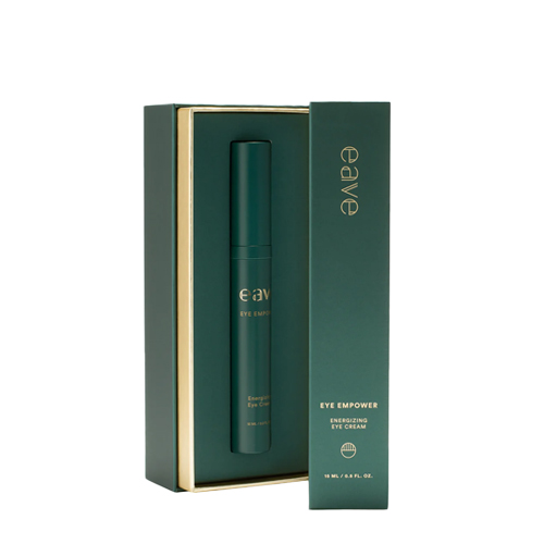 De geopende luxe verpakking van de EAVE Eye Empower oogcrème, waarbij de tube in een gouden omlijsting wordt gepresenteerd.