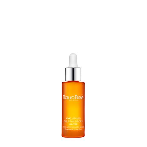 Een oranje glazen flacon van de Natura Bissé C+C Vitamin Self-Tan Drops met een witte druppelteller.