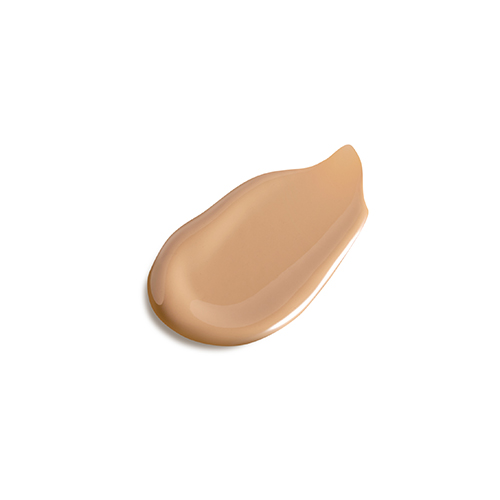 Een swatch van de vloeibare, beige getinte zonnebrandcrème op een witte achtergrond.