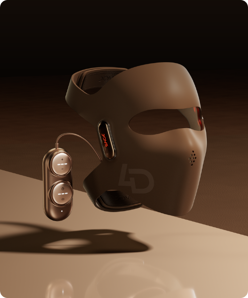 Een modern bruin JOVS LED gezichtsmasker dat zweeft boven een glanzend oppervlak. Aan het masker is een ovaalvormige bronzen afstandsbediening met knoppen en indicatielampjes bevestigd via een kabel.