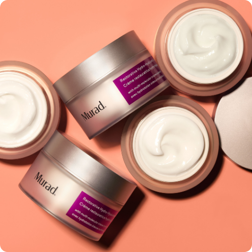 Meerdere open potten Murad Restorative Hydro Dynamic Crème gevuld met rijke witte gezichtscrème