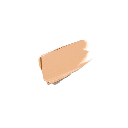 Een romige veeg van Jane Iredale Enlighten Plus Under-eye Concealer in kleur no. 0 op een witte achtergrond. De textuur laat een lichte, egale peachy beige-tint en de vloeibare, dekkende formule zien.