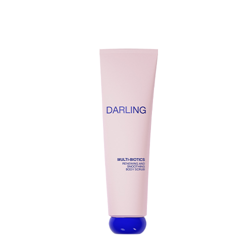 Een studio-opname op een witte achtergrond van een lichtroze staande tube Darling Multi-Biotics Renewing and Smoothing Body Scrub, met een opvallende, kobaltblauwe ronde dop aan de onderkant. De tekst op de tube is in blauw gedrukt.