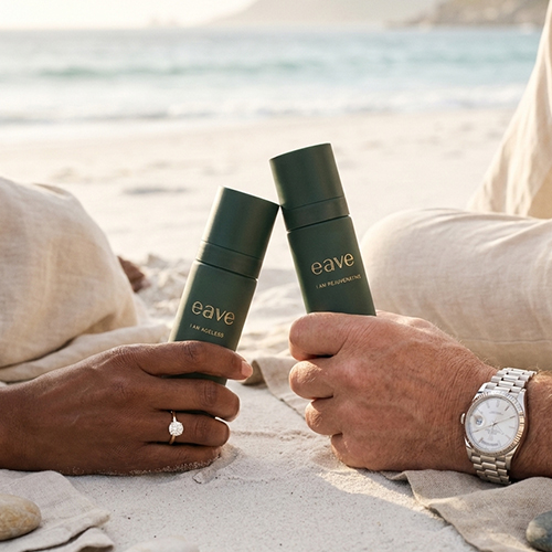 Twee personen houden EAVE huidverzorgingsproducten vast op een zonnig strand