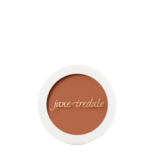 Een ronde compactdoos van Jane Iredale Enlighten Concealer in Dark Intense Peach op een witte achtergrond. Bevat een egale, diepere perzik oranje-bruine concealertint met het merklogo op de voorkant.