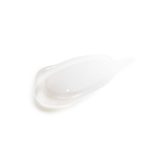 Een swatch van de transparante, lichte geltextuur van de Natura Bissé warming gel op een witte ondergrond, die de vloeibare en glanzende consistentie laat zien.