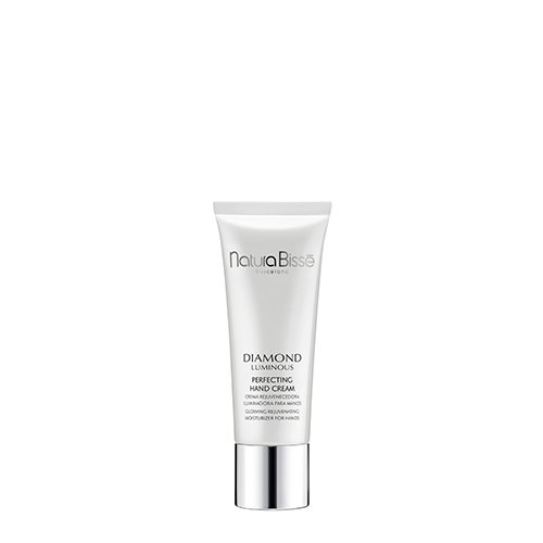 Een staande tube Natura Bissé Diamond Luminous Perfecting Hand Cream met zilverkleurige dop, gecentreerd tegen een effen witte achtergrond.