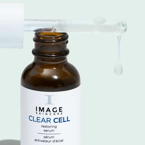 Close-up van het pipetje van het IMAGE Skincare Clear Cell Restoring Serum waar een druppel transparant serum uitloopt.