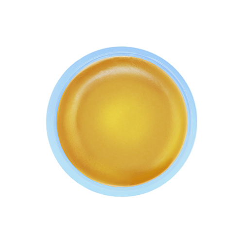 Een bovenaanzicht van de geopende zonnebrandstick die de gladde, goudgele en transparante textuur van het product laat zien.