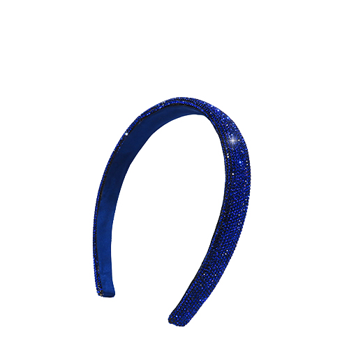 Een schuine close-up van de glinsterende blauwe Nimya haarband die het licht vangt.