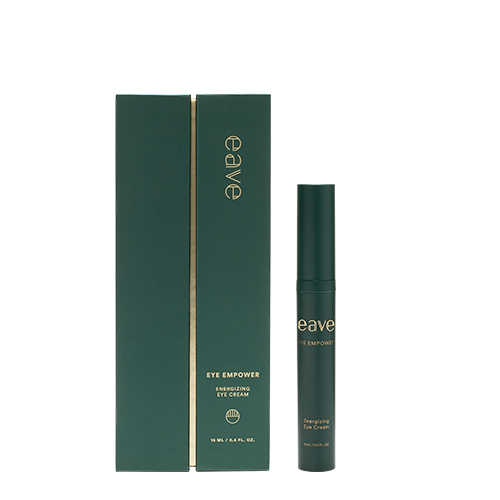 De EAVE Eye Empower Energizing Eye Cream tube staand naast de bijbehorende luxe donkergroene verpakking met gouden details.