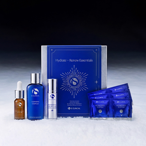 iS Clinical Hydrate + Renew Essentials cadeaupakket gepresenteerd in een winterse setting met sneeuw en een sfeervolle achtergrond