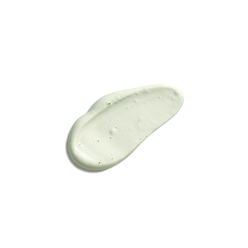 Een dikke, lichtgroene crème-textuur van het Natura Bissé Stabilizing Cleansing Mask met kleine zuiverende deeltjes.