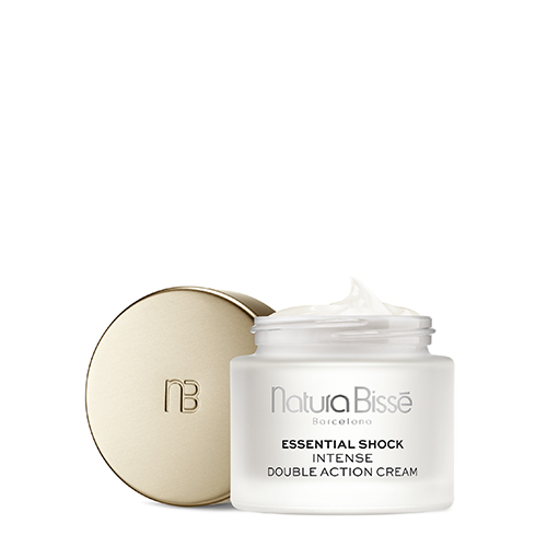 Een geopende pot Natura Bissé Essential Shock Intense Double Action Cream met een zichtbare hoeveelheid crème en de losse gouden dop ernaast.