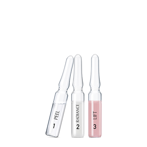 De drie stappen van de Natura Bissé Diamond Instant Glow kuur: Peel, Radiance en Lift, gepresenteerd als losse glazen ampullen.