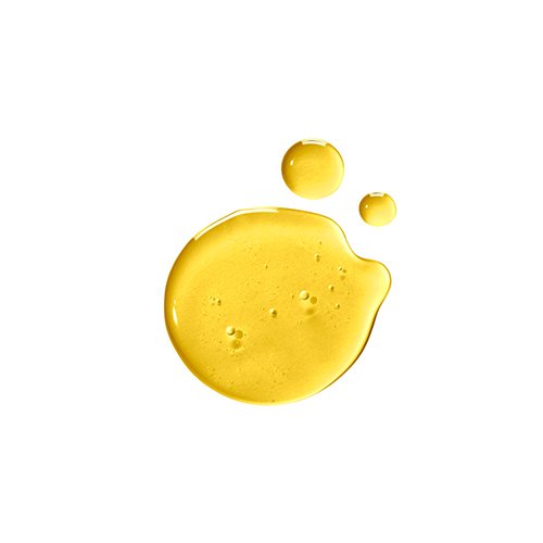 Glanzende, amberkleurige druppels van de Natura Bissé Energizing lichaamsolie op een witte ondergrond.