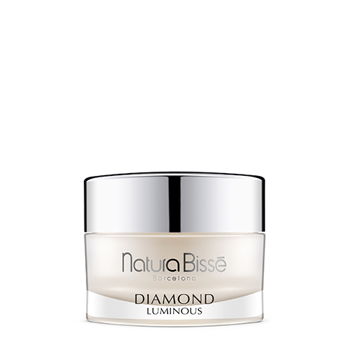 Een luxe glazen pot van Natura Bissé Diamond Luminous Rich Luxury Cleanse met een zilveren deksel tegen een witte achtergrond.