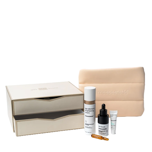 Mesoestetic Iconic Glow holiday set met een beige opbergdoos met lades beige toilettas en huidverzorgingsproducten zoals Age Element Brightening Cream en AOX Ferulic