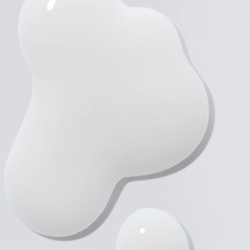 Een close-up van de vloeibare, witte en melkachtige textuur van de Darling Milky Hair Screen op een glad oppervlak.