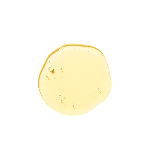 Een druppel goudkleurige olieachtige textuur van HydroPeptide Moisture Reset met kleine luchtbelletjes op een witte achtergrond