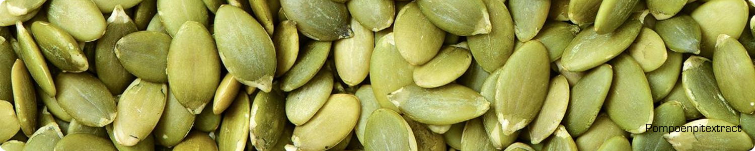 Een bovenaanzicht van een grote hoeveelheid gepelde, groene pompoenpitten waaruit het extract wordt gewonnen.