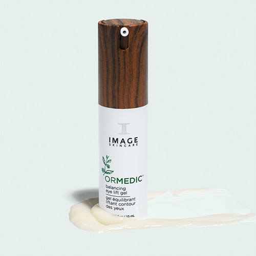 De ORMEDIC Balancing Eye Lift Gel tube stijlvol gepresenteerd op een lichte achtergrond naast een frisse swatch van de gelige gel.