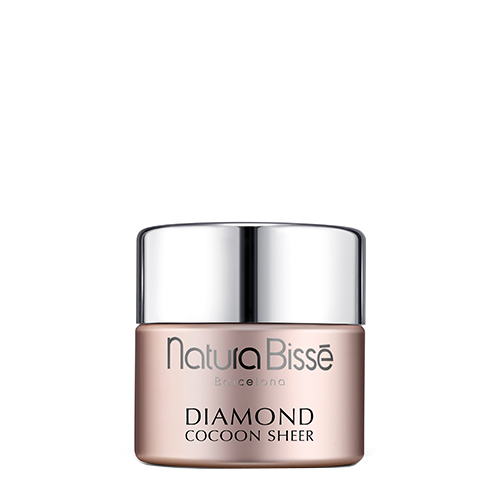 Een luxe parelmoer roze pot van Natura Bissé Diamond Cocoon Sheer Cream met een zilveren deksel.