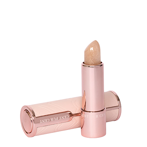 Een open Cent Pur Cent-lippenstift in rose goud, met een glinsterende, goudkleurige lippenbalsem-textuur, staat rechtop naast de dop, die op zijn zijkant ligt op een witte achtergrond.